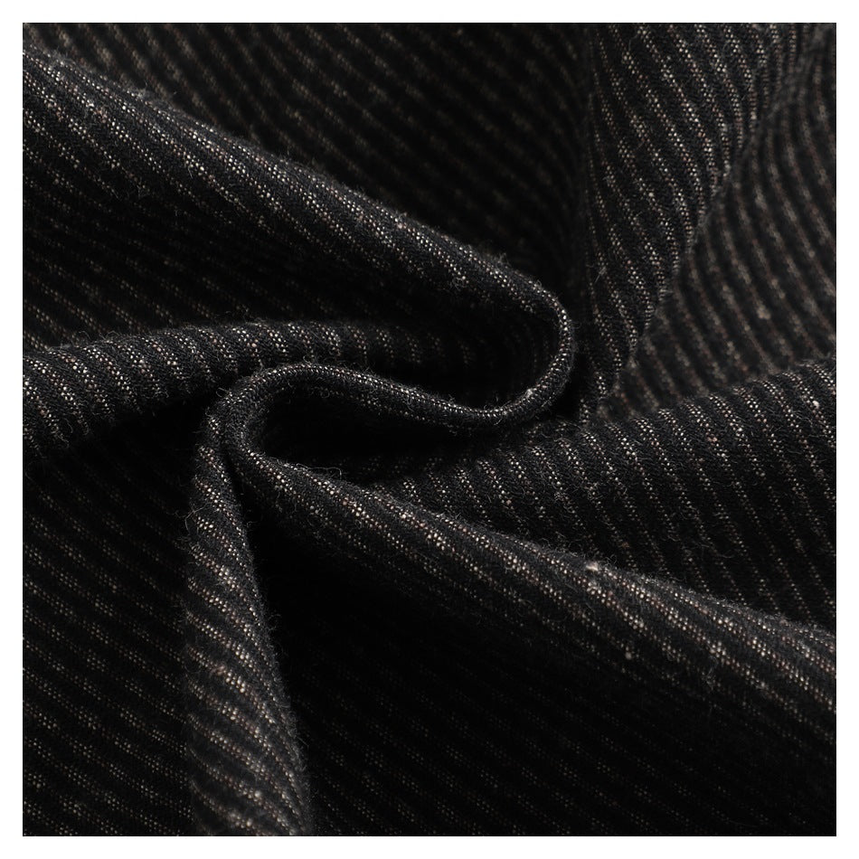 Macro view of dark fabric with fine brown stripes, gathered into soft folds.