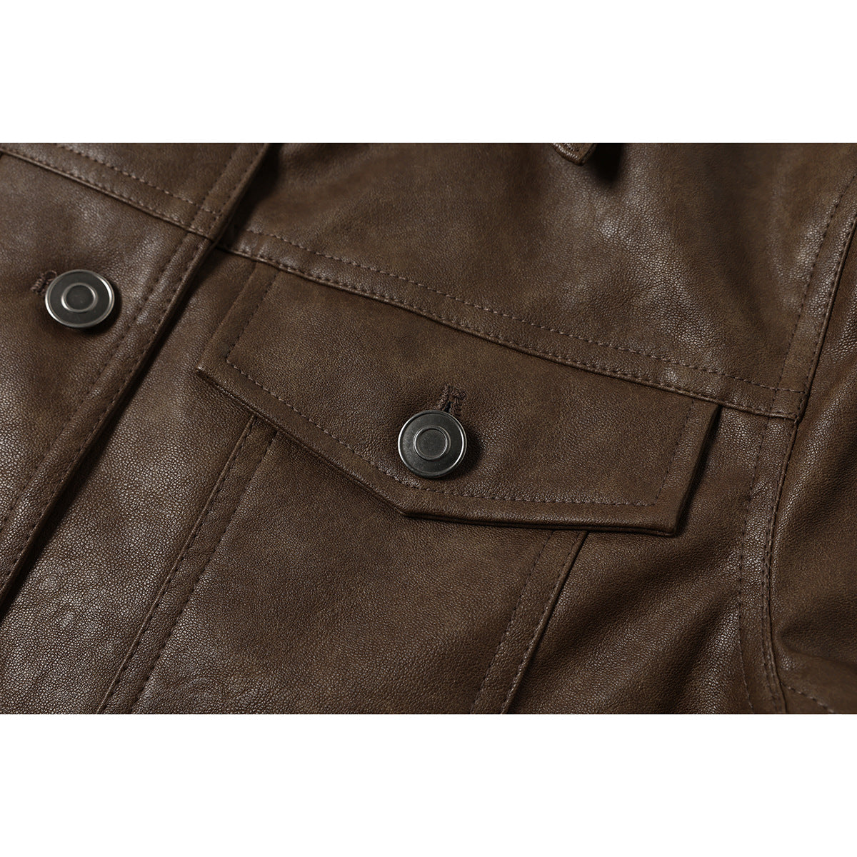 Close-up of a dark brown jacket's flap pocket with a round metal snap and visible stitching.