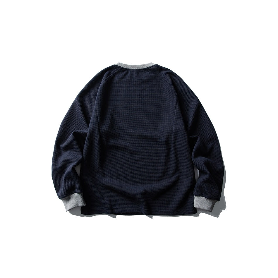 Back view of navy waffle-knit sweatshirt with gray ribbed collar and cuffs and plain back