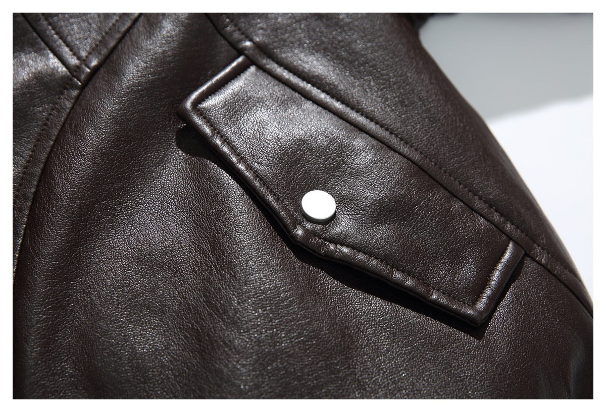 Close-up of a dark brown jacket pocket flap with a silver snap and visible stitching.
