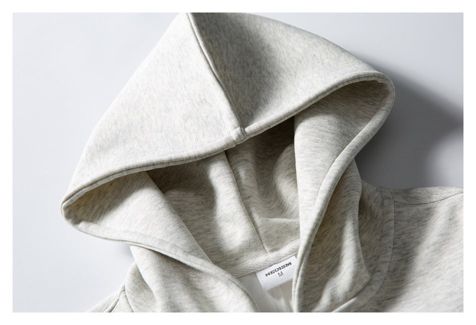 Close-up of a light gray heather sweatshirt hood and neck label, showing the hood's panel seams.