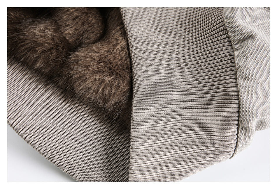 Close-up of the jacket's ribbed knit trim beside brown fur lining and light taupe fabric.