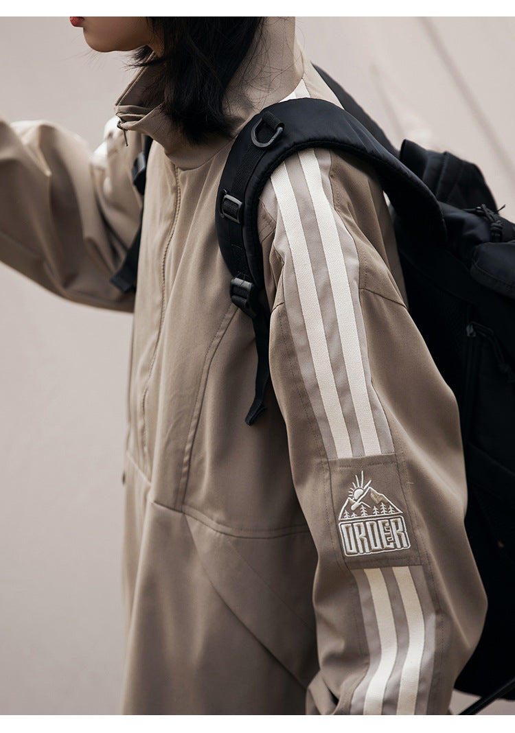 Close-up of the jacket’s cream sleeve stripes and embroidered mountain graphic.