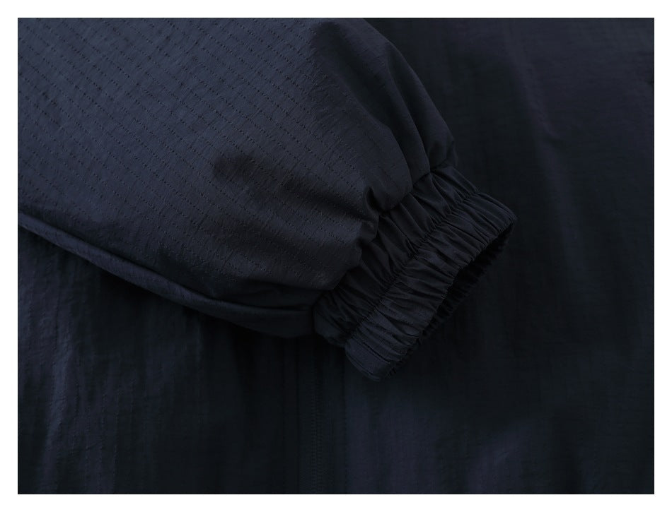 Close-up of a dark navy sleeve ending in a gathered elastic cuff.