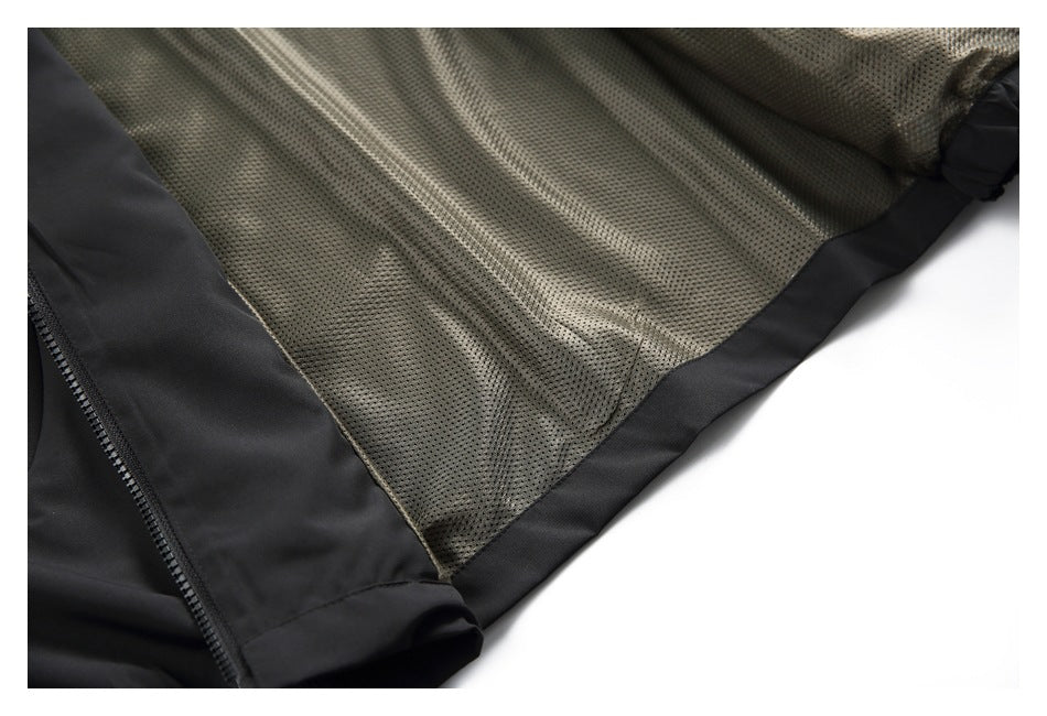Close-up of the jacket's gray perforated mesh interior lining and black edging.