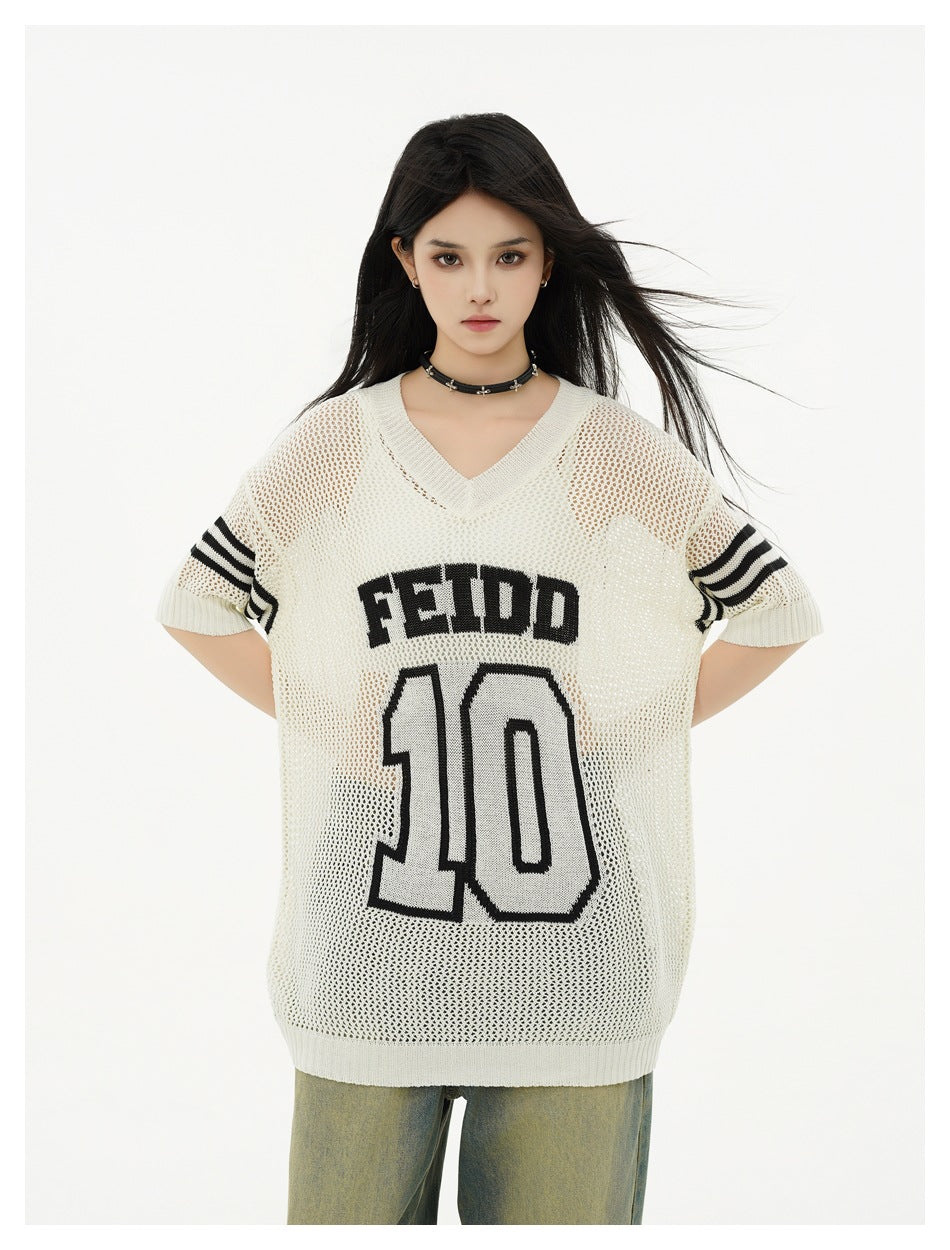Front view of a model wearing an ivory mesh tunic with black striped sleeves and FEIDD 10 lettering.
