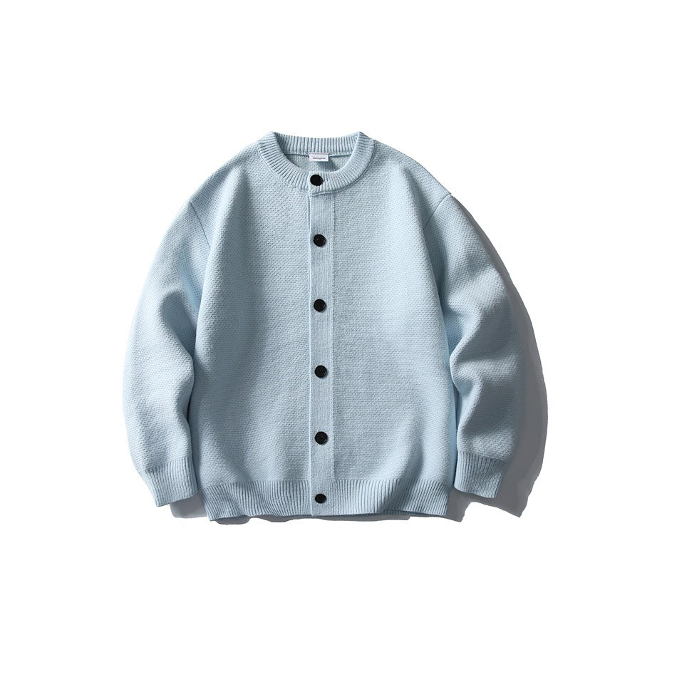 Front view of a pale blue long-sleeve knit cardigan with a round neck, black buttons, and ribbed trim.