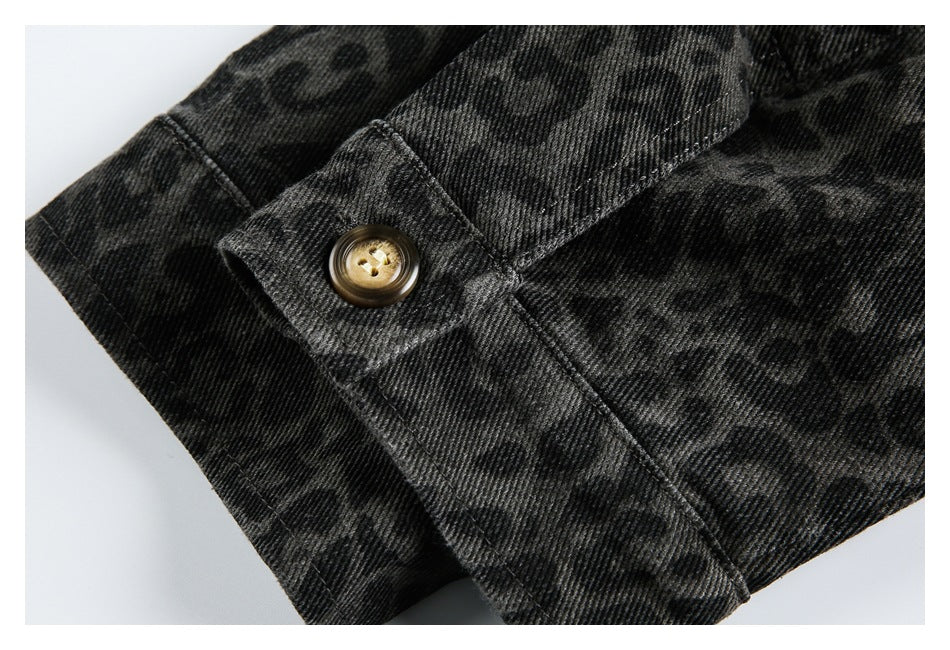Close-up of a brown button on a tab over dark charcoal leopard-print fabric.