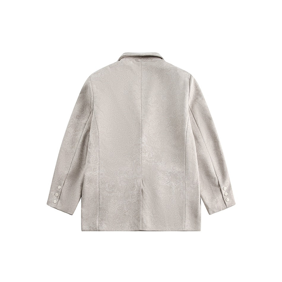 Back view of a light gray blazer with a subtle tonal floral pattern, center seam, and three buttons at each cuff.