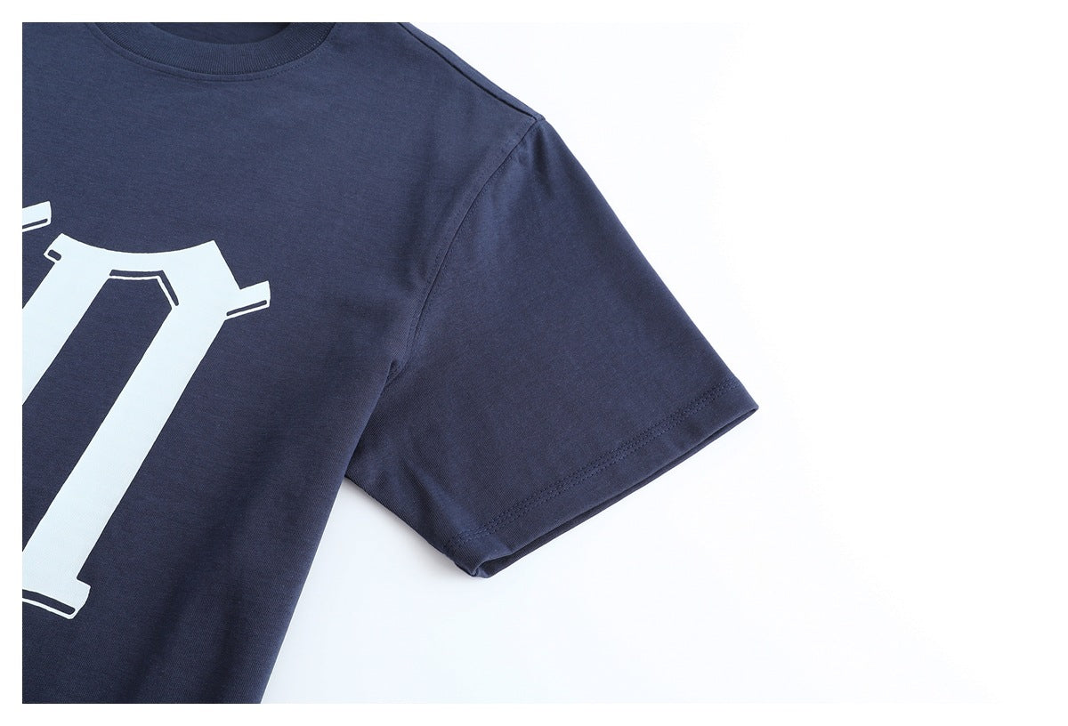Close-up of a dark navy crew-neck T-shirt showing the neckline, shoulder, and short sleeve.