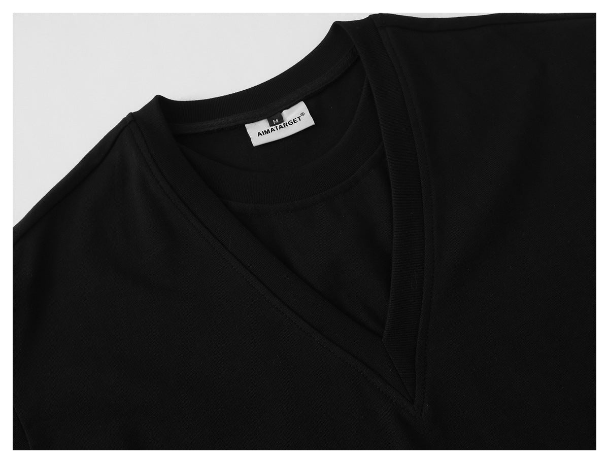 Close-up of the black shirt's V-neck trim and sewn-in AIMATARGET size M label.