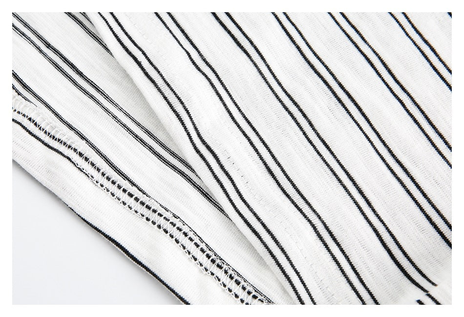 Close-up of the white striped garment's fabric and overlocked seam.