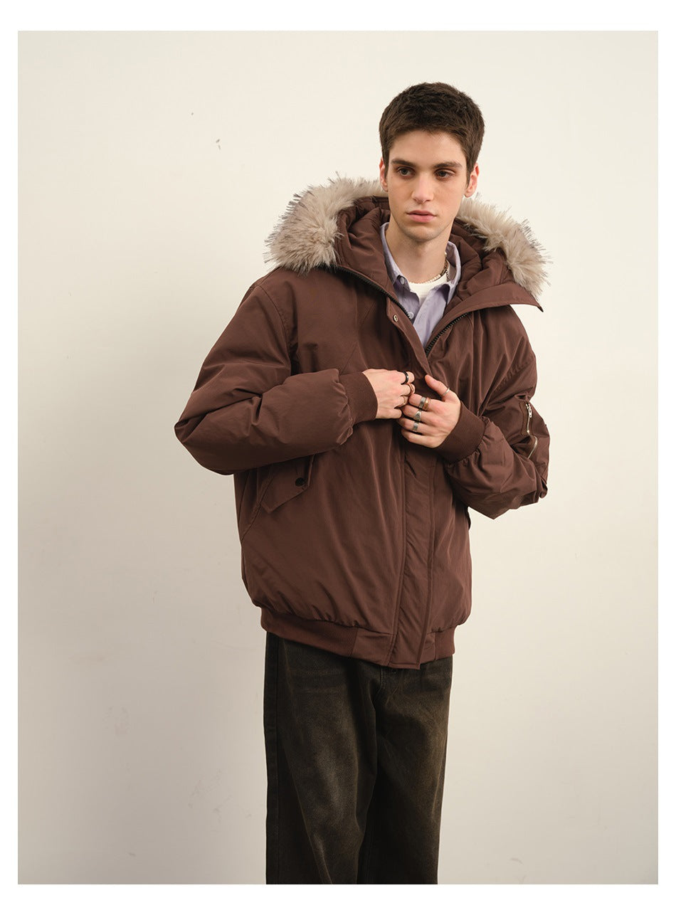 Model poses in a dark brown padded jacket with a beige fur-trimmed hood, shown from the front at an angle.