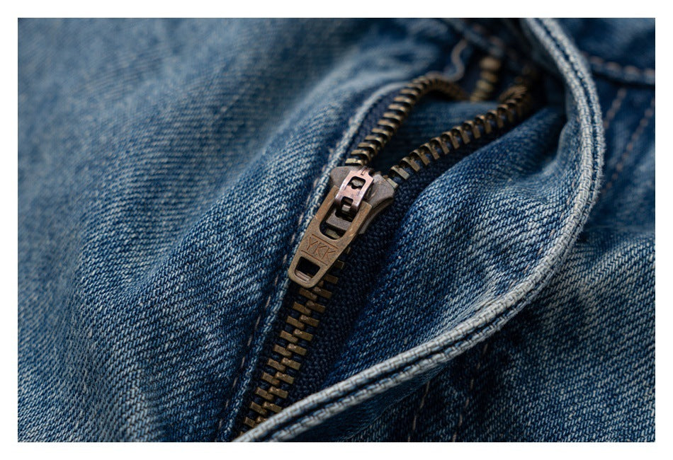 Close-up of a metal zipper and fly on blue denim jeans.