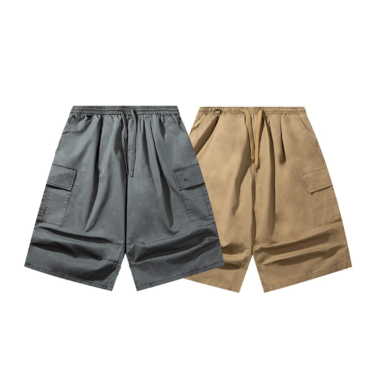 Two pairs of wide-leg cargo shorts shown from the front in charcoal gray and tan, with elastic waists and drawstrings.