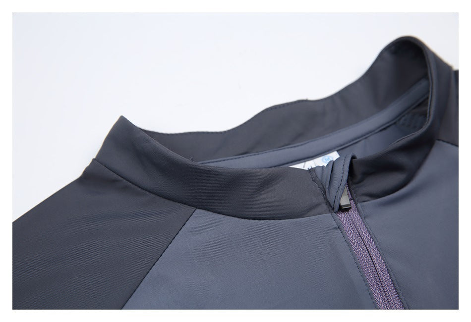 Close-up of the gray top’s dark stand collar and short purple-gray zipper.