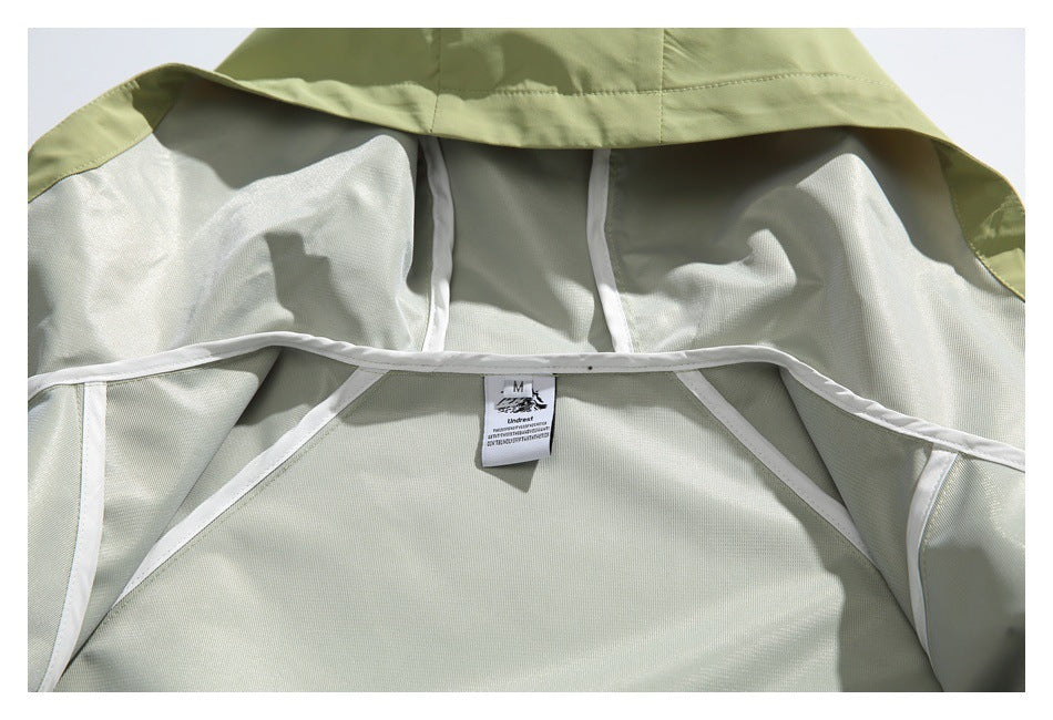 Close-up of a pale sage garment interior with white seam binding and a small size M label.