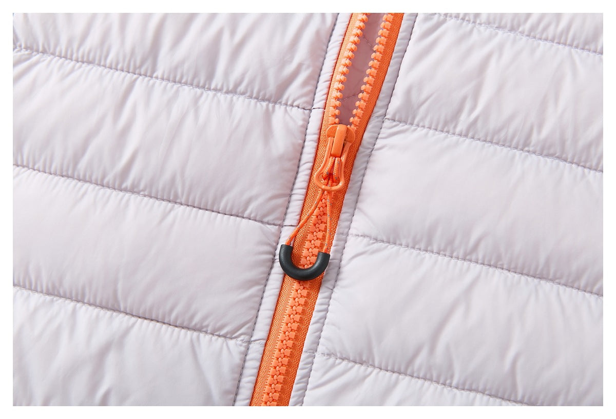 Close-up of the pale lavender quilted jacket's bright orange front zipper and pull.