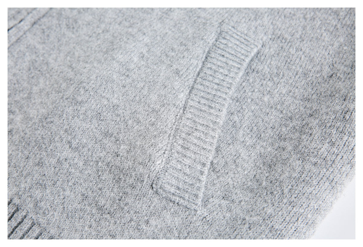 Close-up of light gray knit fabric with a vertical ribbed trim.