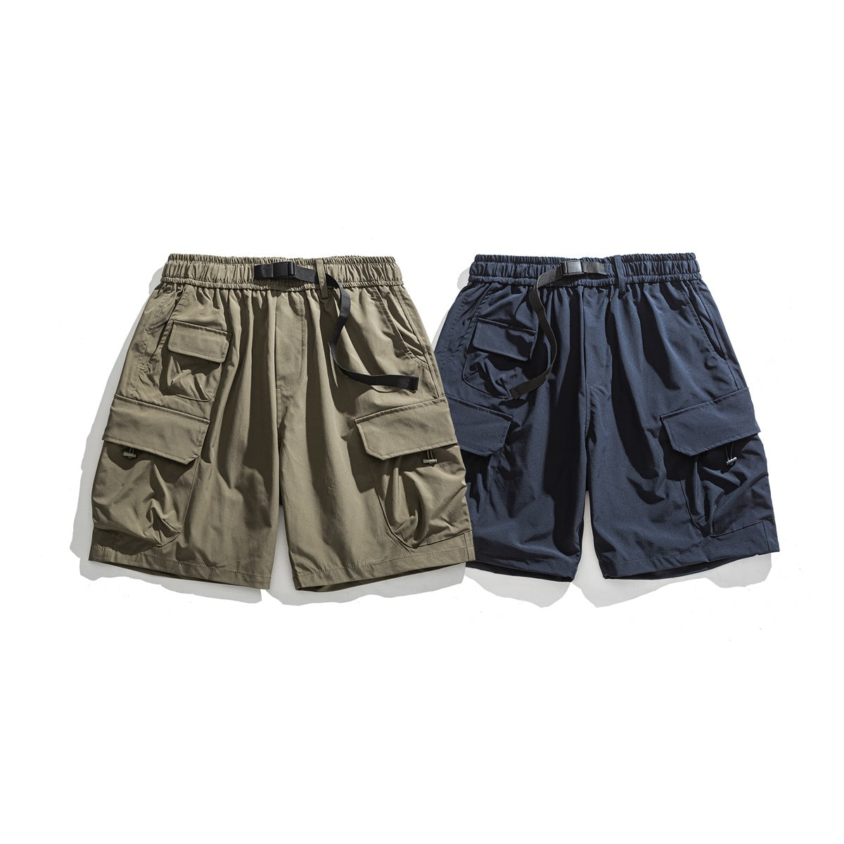 Front view of khaki and navy cargo shorts with elastic waistbands, black straps, and multiple flap pockets.