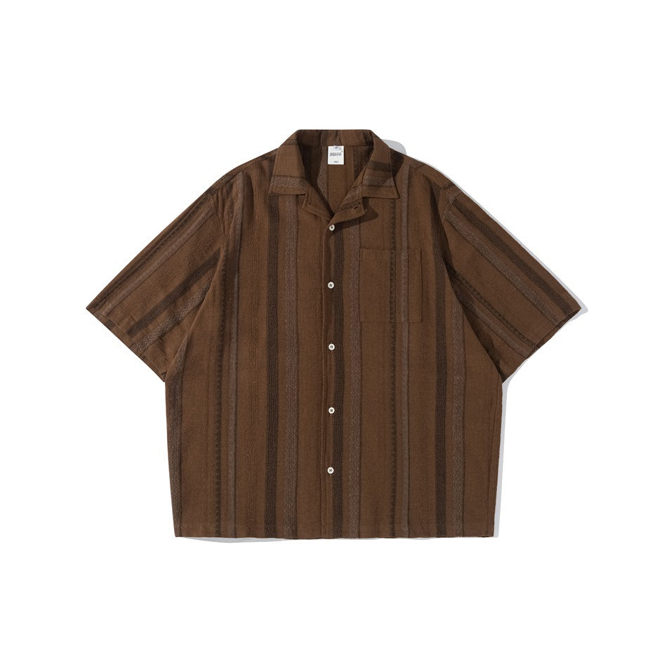 Brown short-sleeve camp collar shirt with tonal vertical textured stripes, button front and chest pocket, flat lay