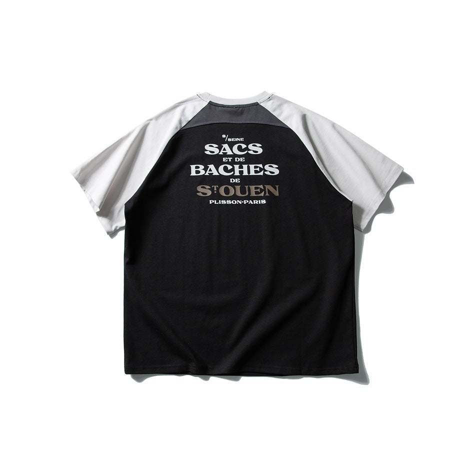 Back of black raglan T-shirt with light gray sleeves, dark gray shoulder panel and white serif text graphic