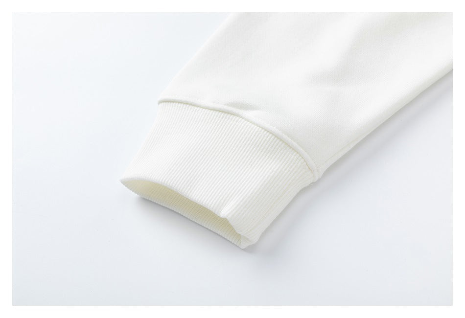 Close-up of a white sweatshirt sleeve ending in a wide ribbed cuff.