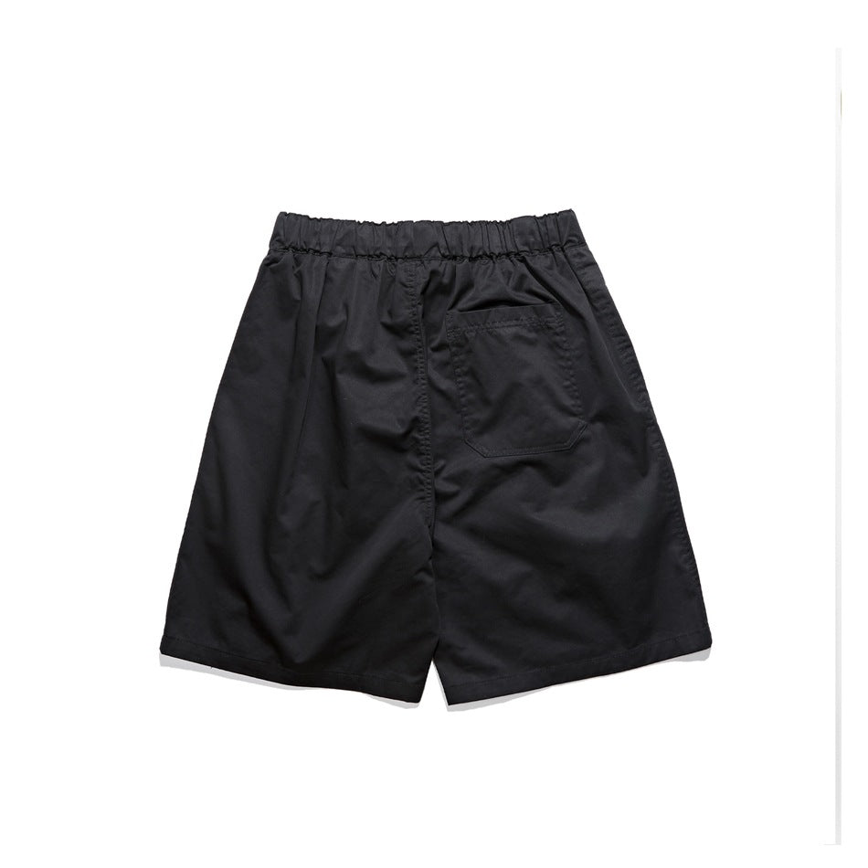 Back view of black shorts with an elastic waistband and a single rear pocket.