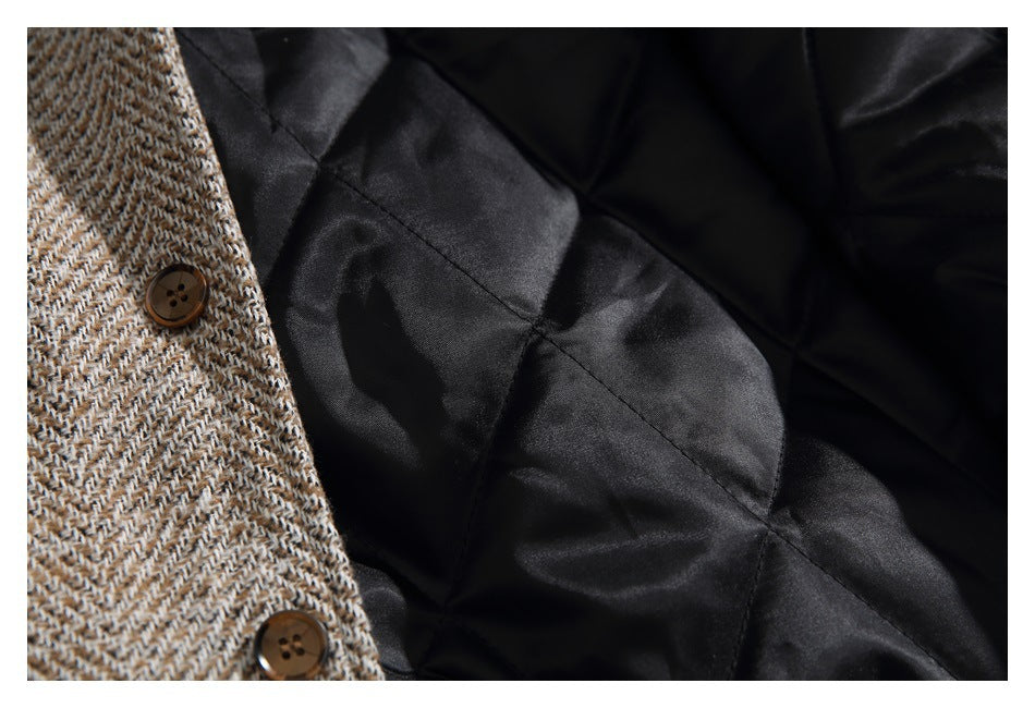 Inside view of a herringbone garment with brown buttons and black quilted lining.