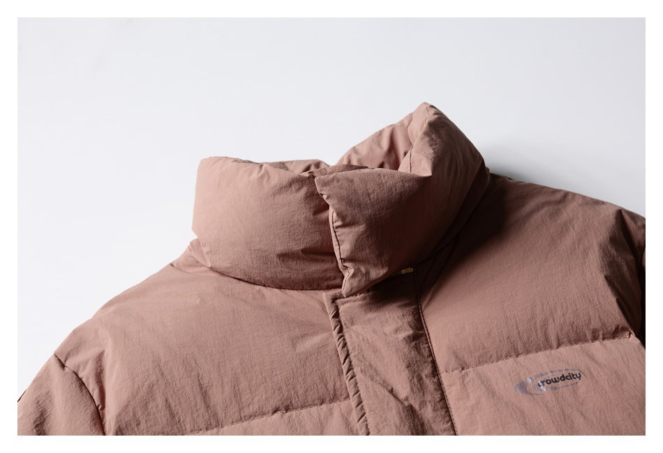 Cropped view of the dusty rose puffer jacket's high collar, front placket and chest logo.