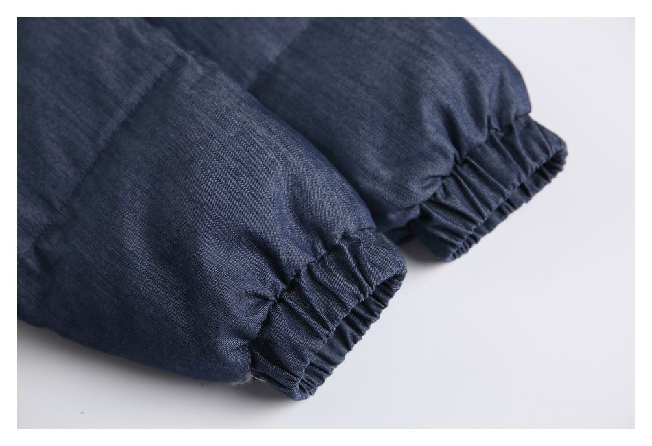 Close-up of the gathered elastic cuffs on a dark blue jacket.