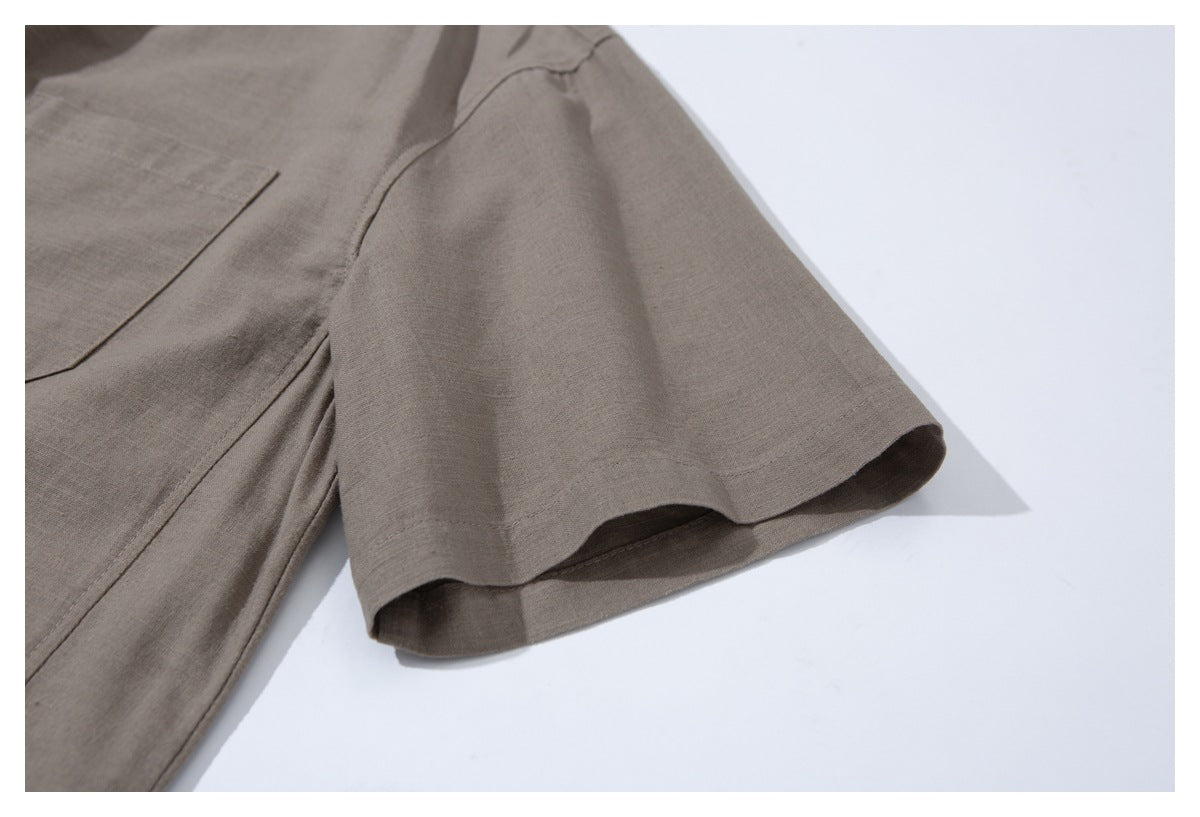 Close-up of the taupe shirt's short sleeve and stitched sleeve hem.