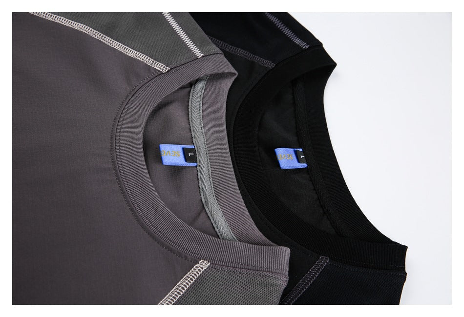 Close-up of gray and black T-shirt necklines showing ribbed collars, interior labels and contrast stitching.