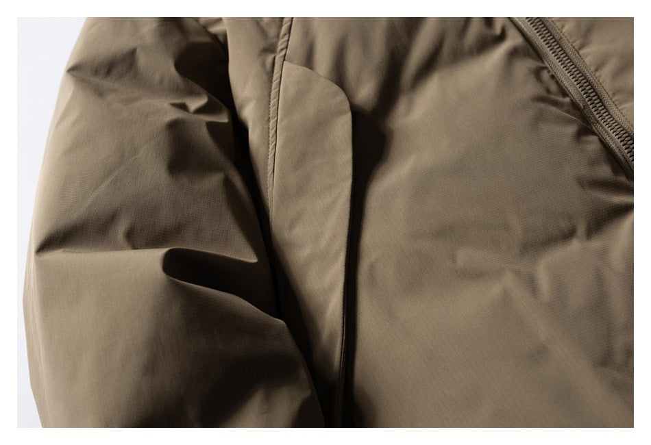 Close-up of a brown jacket sleeve and front panel with a diagonal zipper.