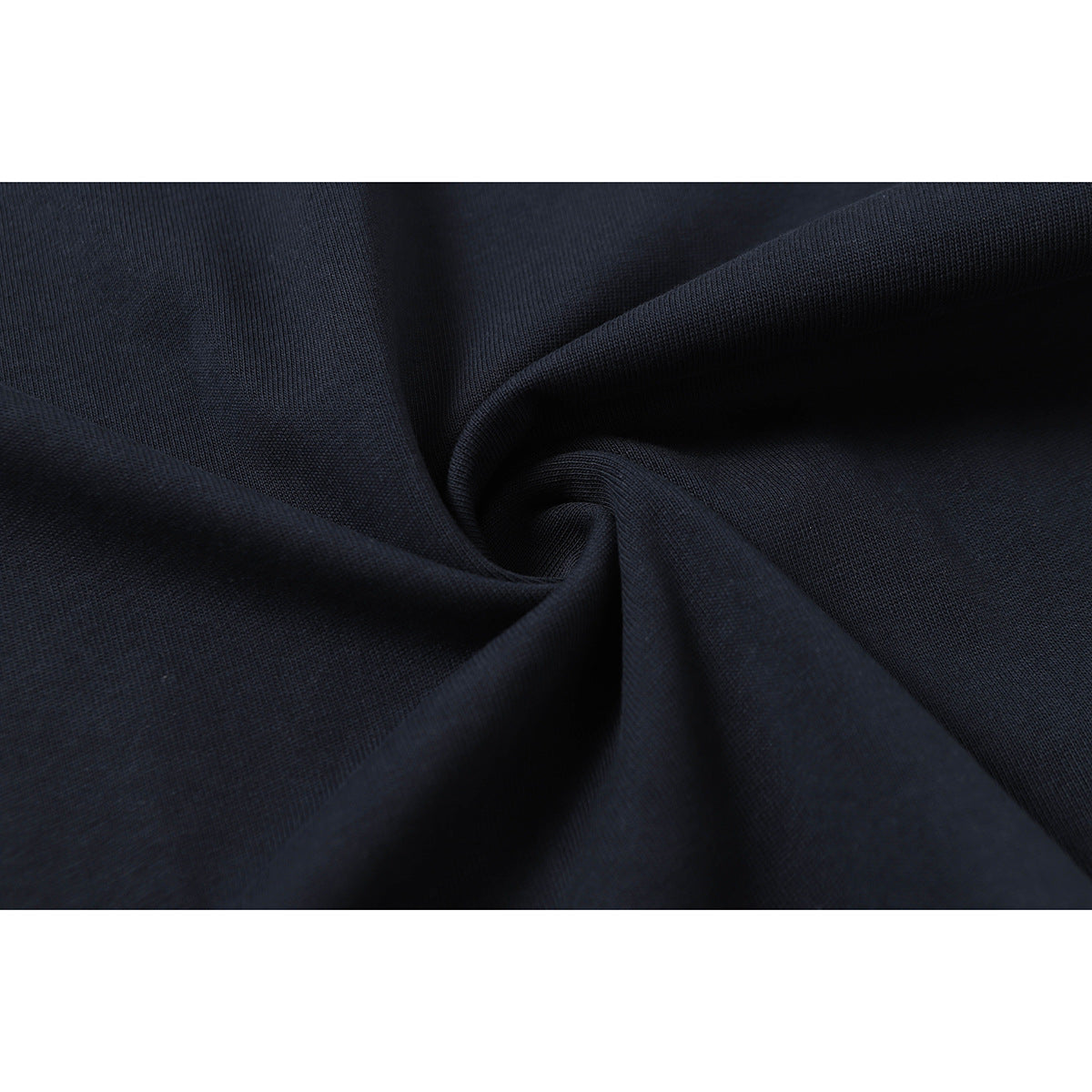 Close-up of dark navy fabric gathered into folds, showing its surface texture.