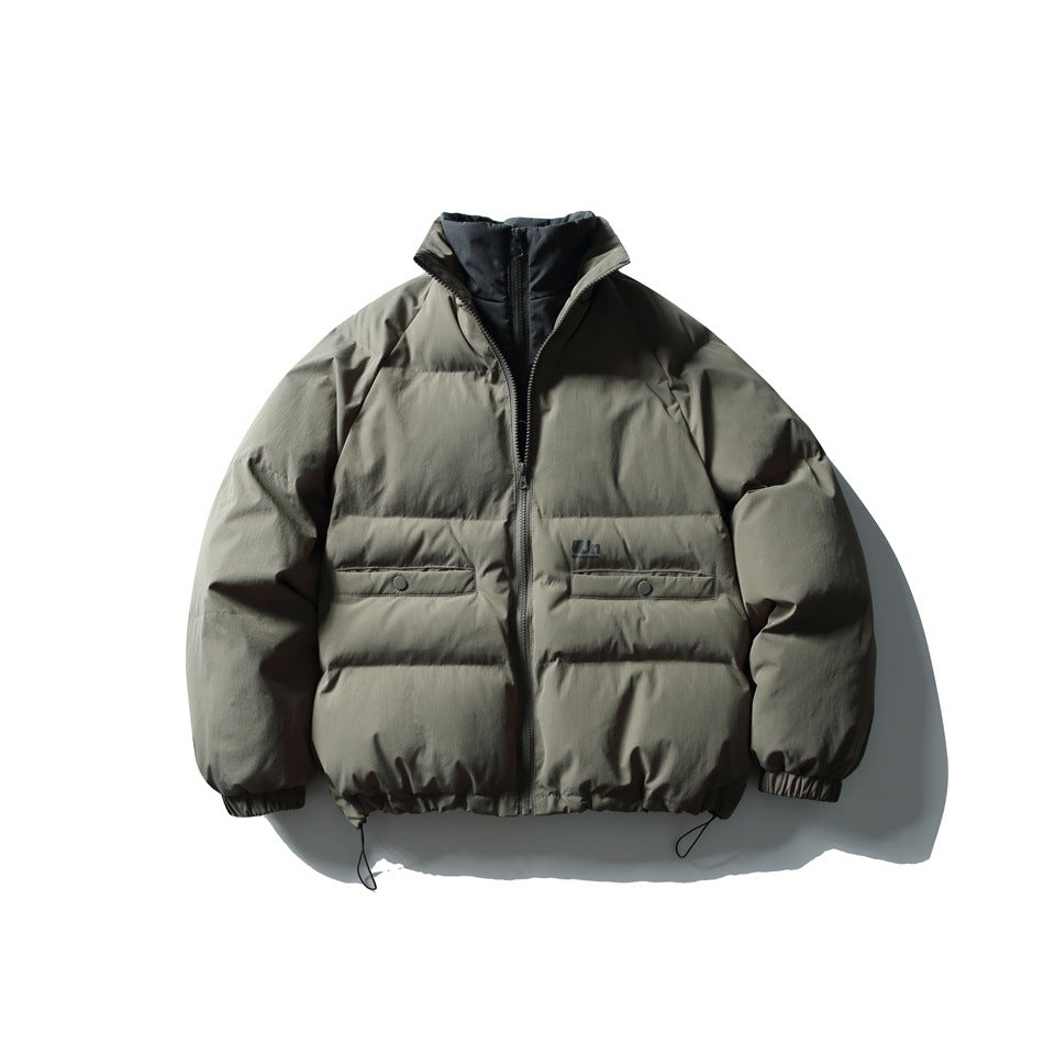Front view of a dark olive-gray padded jacket with a high collar, zip closure, flap pockets, and drawcord hem.
