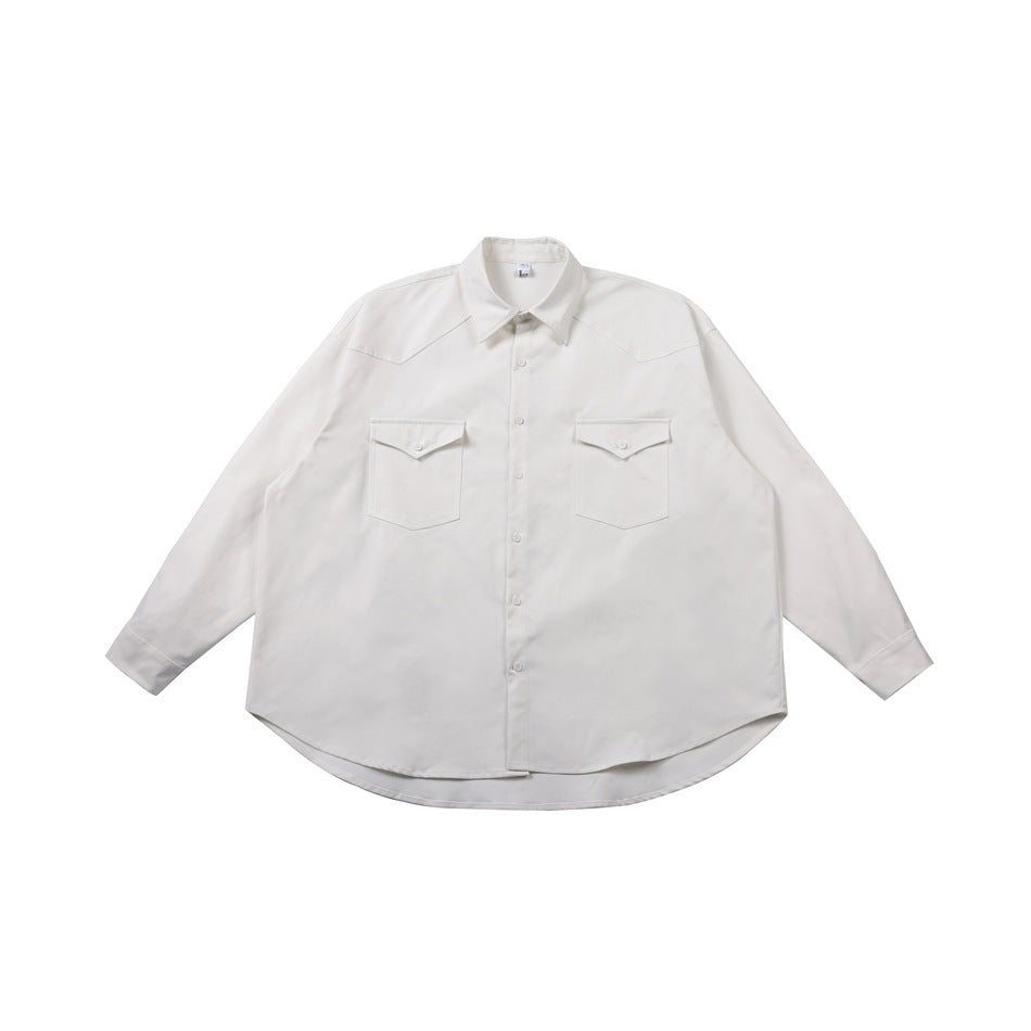 White long-sleeve button-front shirt with two flap chest pockets, shaped yoke and curved hem, laid flat