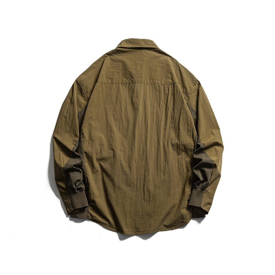 Back view of an olive long-sleeved button-up shirt with a pointed collar and gathered cuffs.