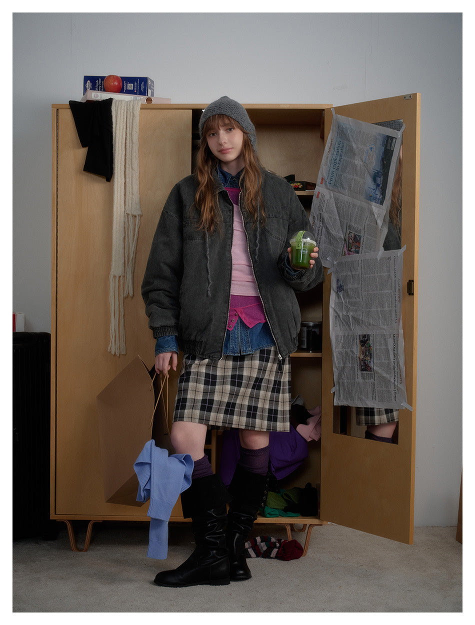 A model wears an oversized charcoal zip-front jacket with a wide collar and gathered cuffs.