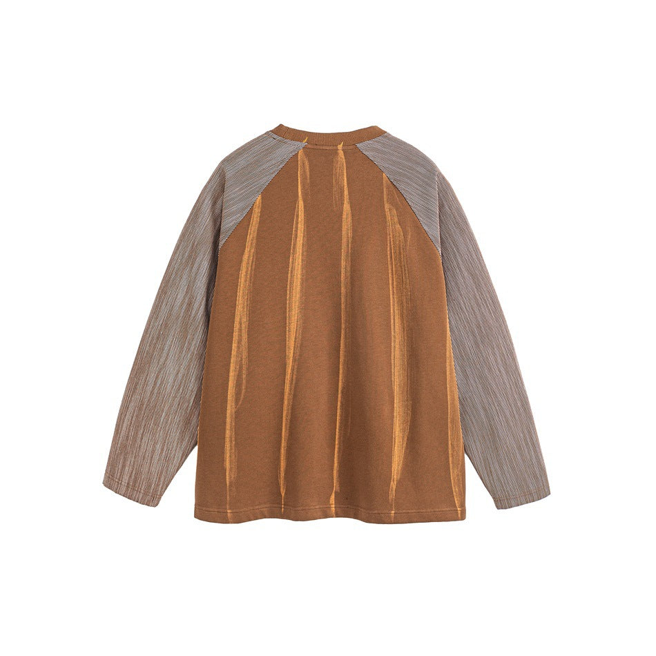 Back view of a rust-brown long-sleeve top with gray pinstriped raglan sleeves and vertical tonal detailing.