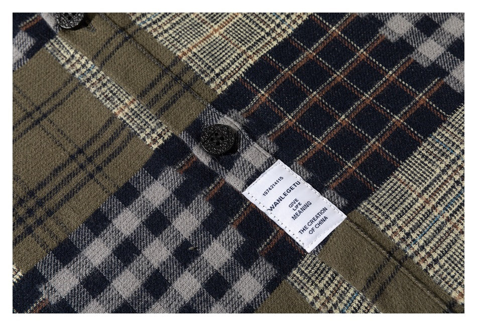 Close-up of a sewn-in white label and black button on a multicolor plaid shirt.