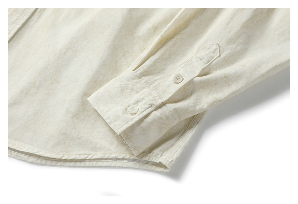Close-up of the shirt's buttoned sleeve cuff and curved hem.