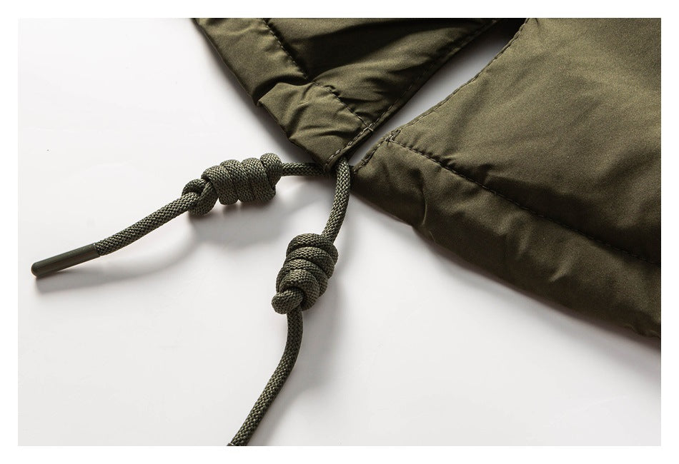 Close-up of olive garment drawcords with chunky knots and a capped end.