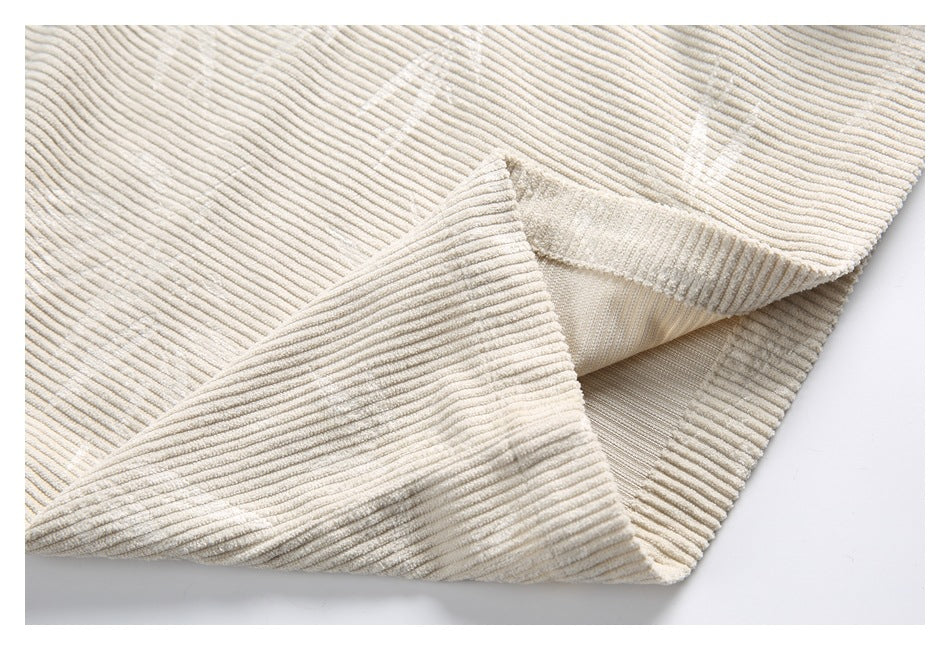 Close-up of the cream tunic's hem and inside seam, showing its ribbed fabric.