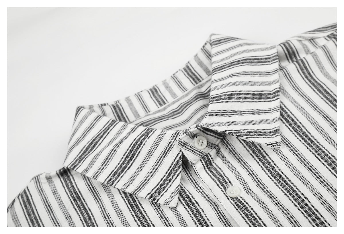 Close-up of the striped shirt's pointed collar and upper button placket.