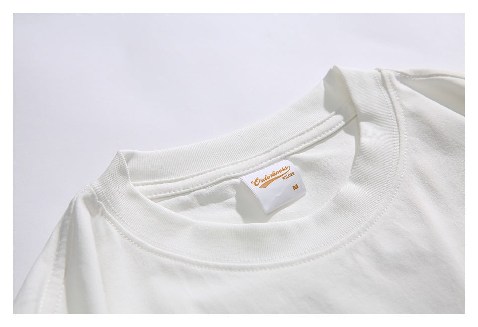 Close-up of the white shirt's ribbed crew neckline and sewn neck label.