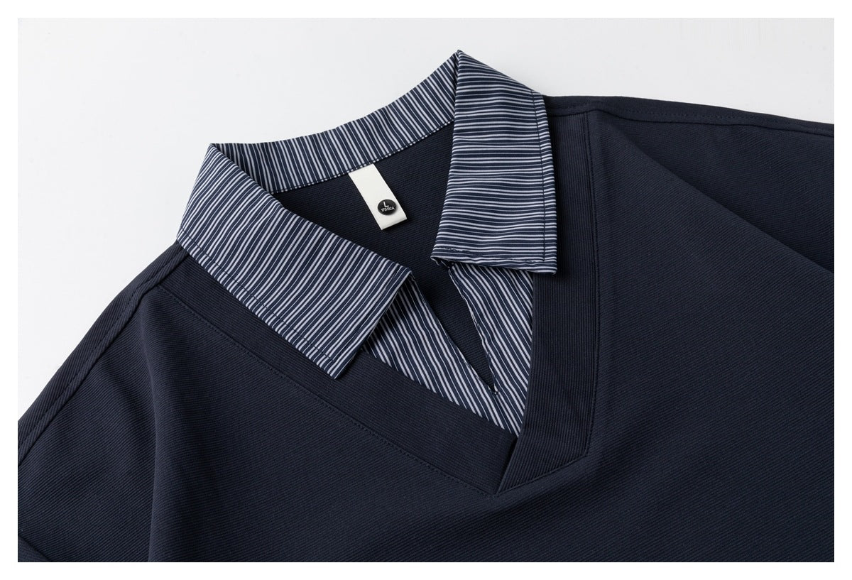 Close-up of the navy polo's collar and V-neck opening, showing narrow white stripes and a small neck label.