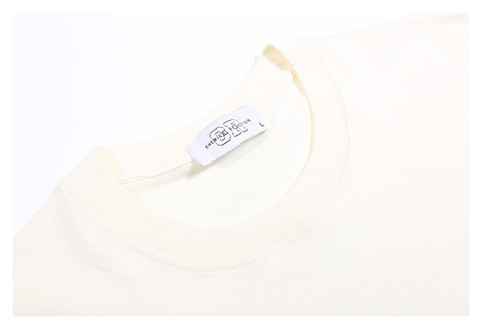 Close-up of an off-white T-shirt crew neckline and attached neck label.