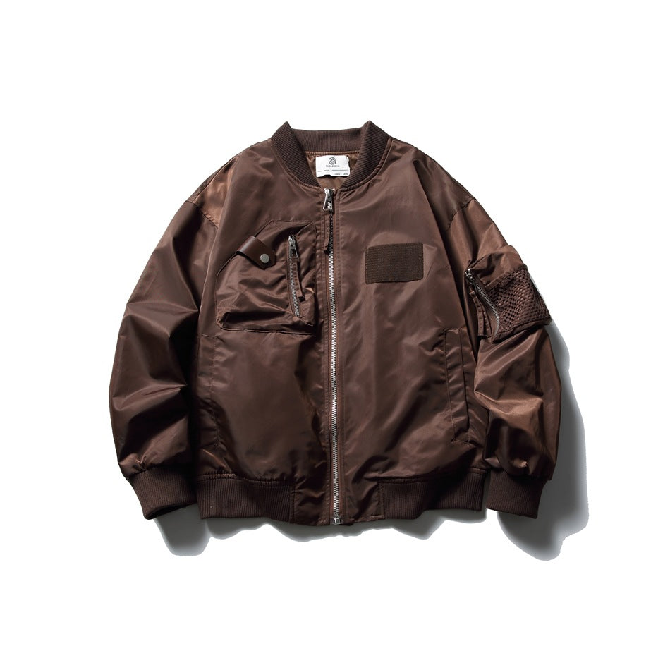 Brown bomber jacket flat lay with ribbed collar, front zipper, chest zip pocket, chest patch and mesh sleeve pocket
