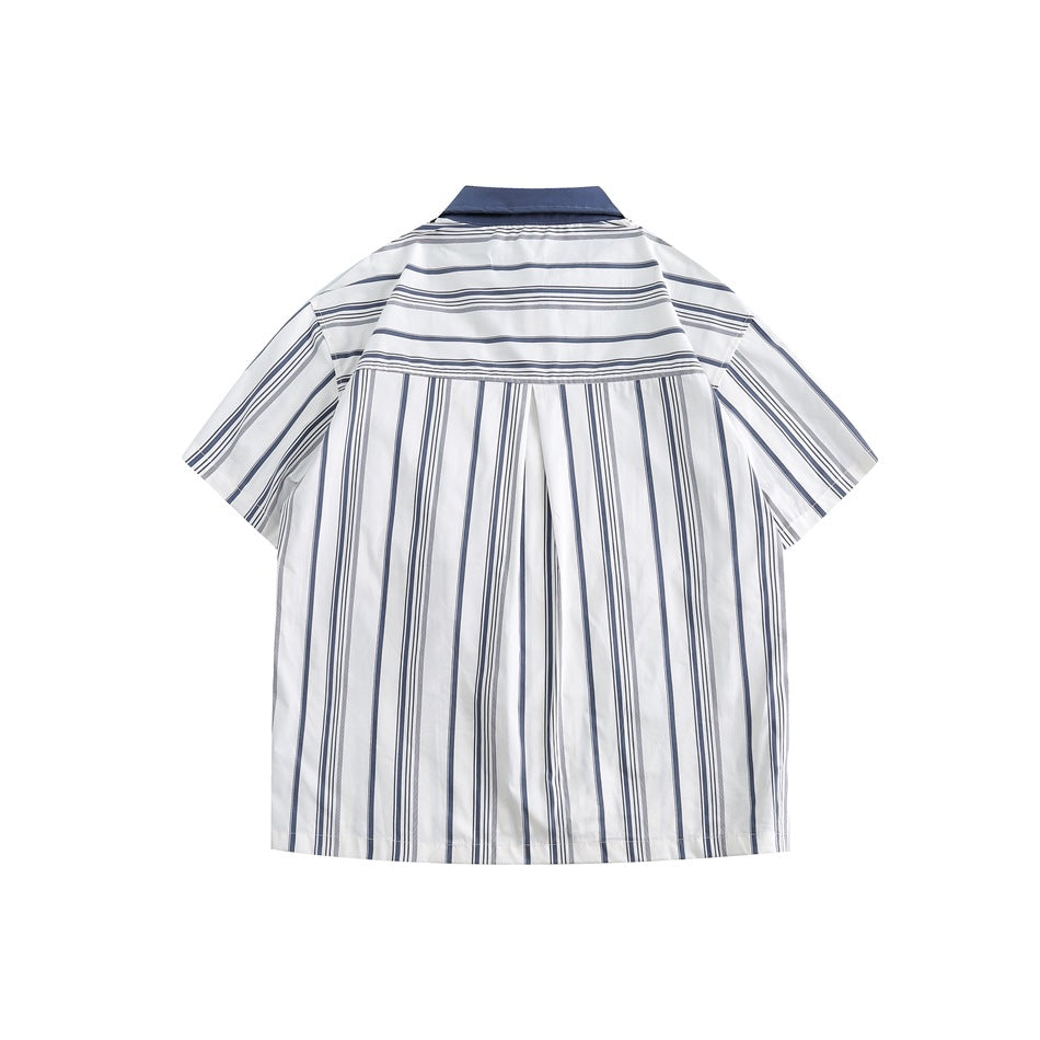 Back of navy and white striped short-sleeve shirt with horizontal-striped yoke and center pleat, flat lay